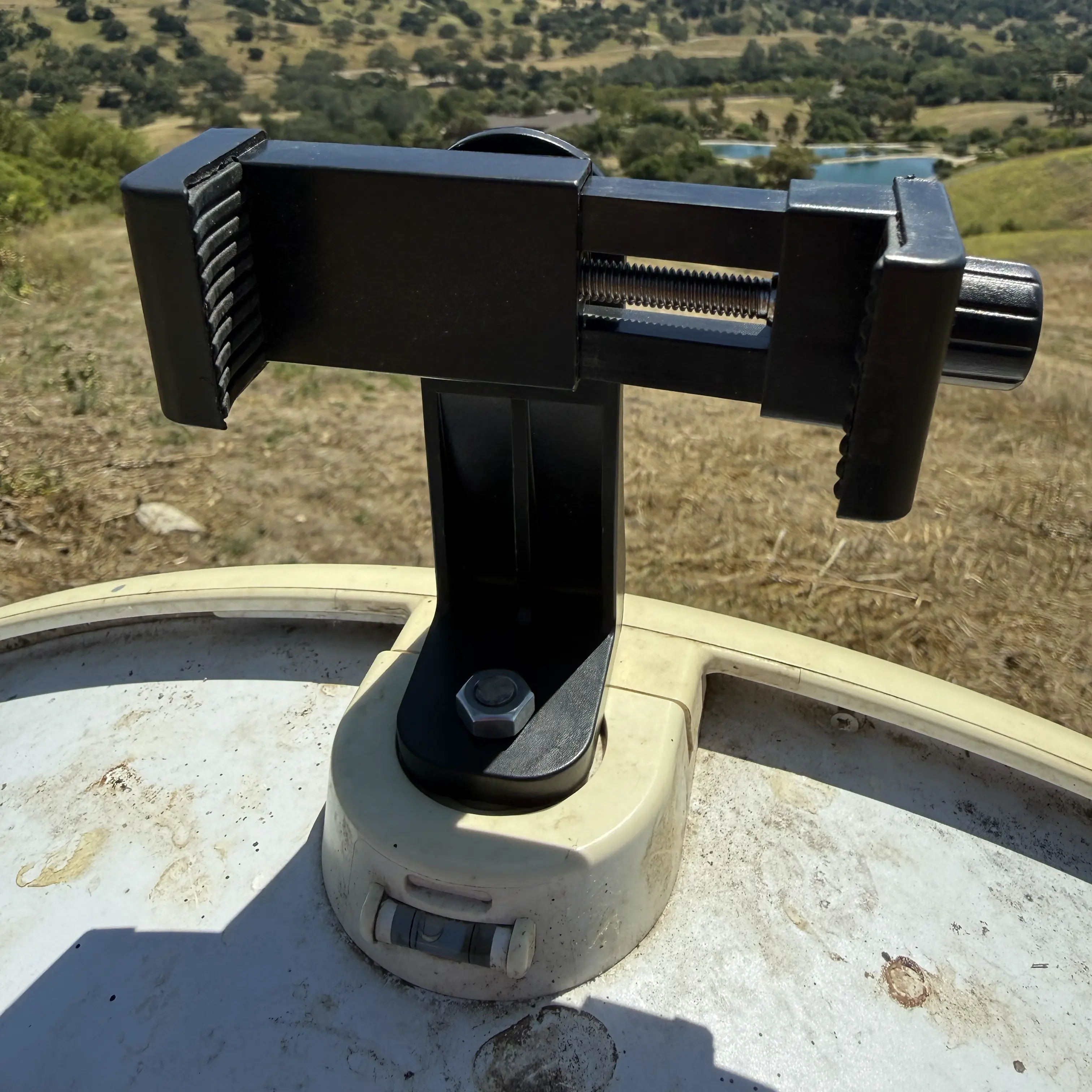 Phone holder attached to AirFiber 60 XR via the built-in ¼-20 tripod boss